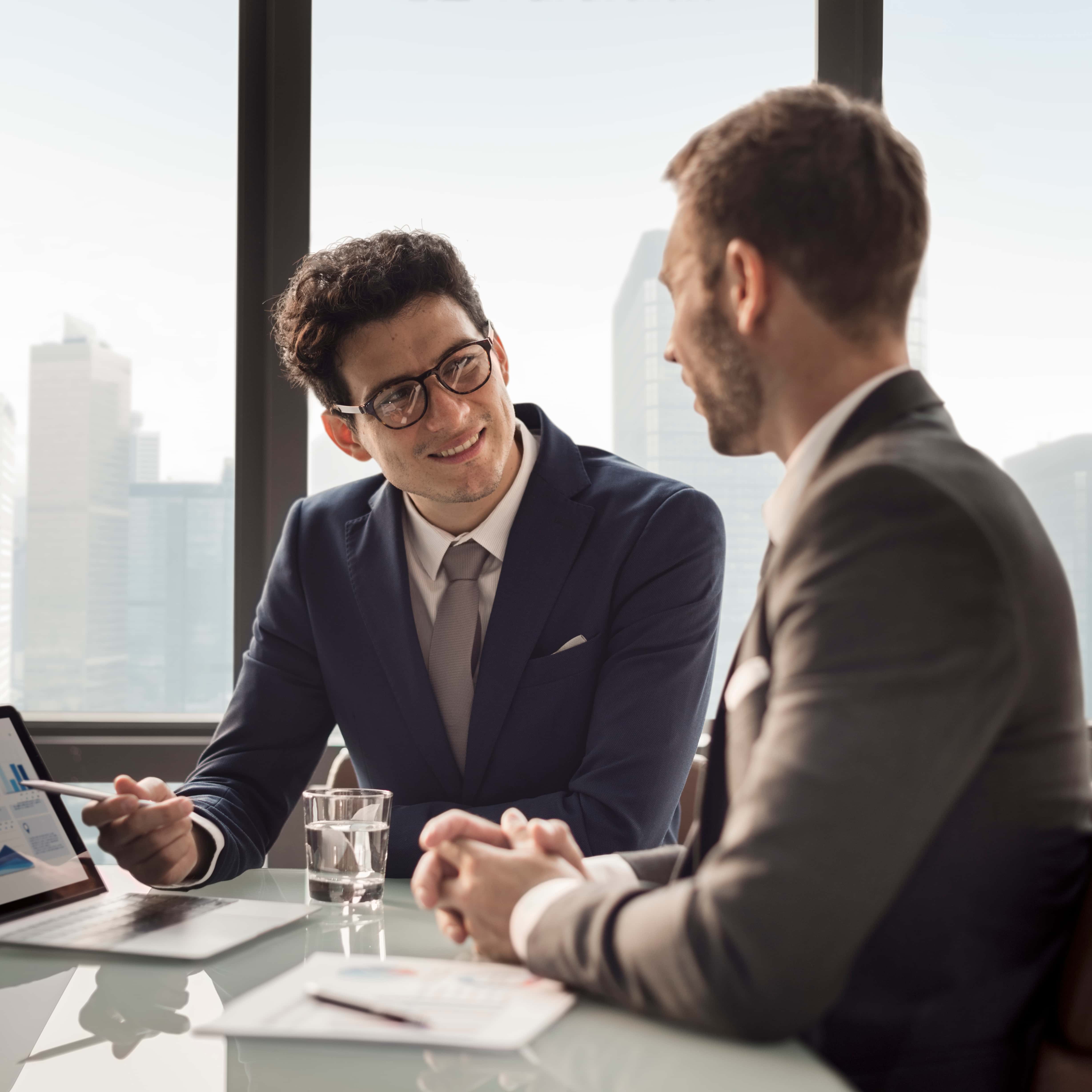 Business professionals discussing charts at a table